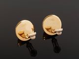 a pair of gold and white enamel cufflinks