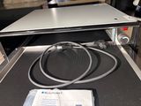 a laptop computer sitting on top of a conveyor belt