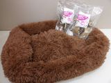a dog bed that has a bag of treats in it