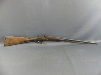 a rifle with a wooden barrel on a white background