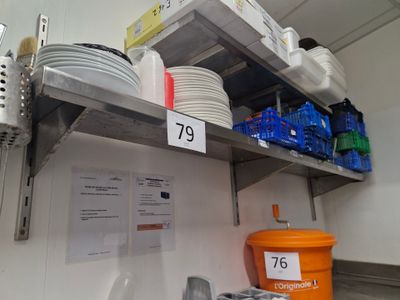 many plates and bowls on the shelves in the kitchen