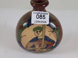 a small vase with a picture of a man on it