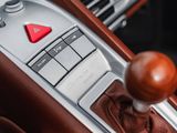 close up of a car ' s gear lever with a red button