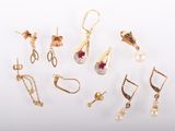 many different types of earrings on a white surface