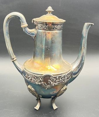 a silver and blue tea pot on a table