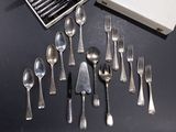 a lot of spoons and forks on the table