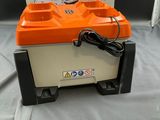an orange and white box with a charger on top of it