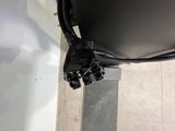 a black bag sitting on the floor next to a black chair