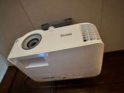 a white projector sitting on top of a wooden floor