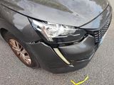 a car that has been damaged and is sitting on the side of the road