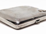 a silver case that is sitting on a white surface