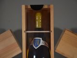 a bottle of wine in a wooden box on a table