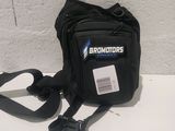 un petit sac noir sur lequel est accrochée une étiquette avec un nom