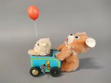 a teddy bear and a teddy bear in a toy train with a balloon