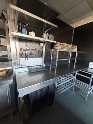 une grande cuisine avec de nombreux plans de travail en inox