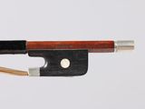 a violin bow that is attached to a piece of wood
