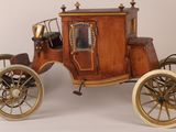 a small wooden horse drawn carriage on a white background