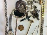 a lot of silver and gold jewelry on a white table