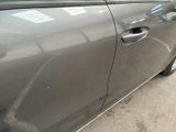 a car that has a broken door handle on the side of the road