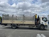 a truck that is parked in a parking lot with other trucks in the background