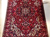 an image of a red rug on a white floor