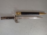 a knife that is laying on a table next to a knife