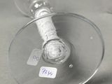 two empty wine glasses on a table with a price tag