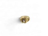 a close up of a gold ring on a white surface