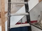 a ladder that is leaning against a wall in a room