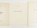 three books are lined up on a white surface