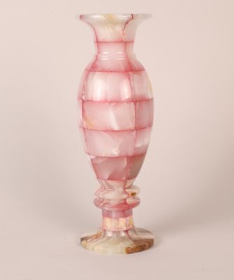 a pink glass vase with a spiral design on it