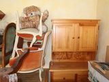 a teddy bear sitting on a chair in a room