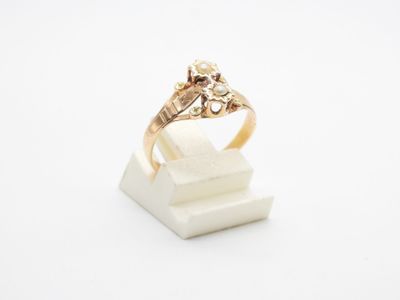 gros plan d'une bague en or surmontée d'un diamant