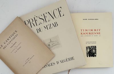 three books sitting on top of a white table next to each other