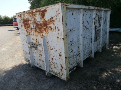 a rusted out refrigerator sitting in the middle of a parking lot
