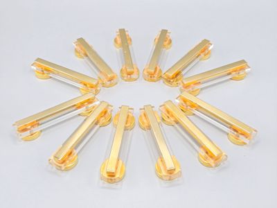 a lot of yellow pills in a circle on a white surface