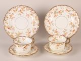 two antique china plates and saucers with floral designs on them