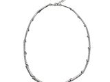a close up of a silver necklace on a white background