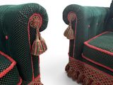two green couches with tassels on them on a white background