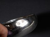 a person holding a silver spoon in their hand