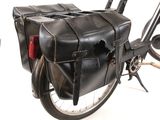 a black leather bag on the back of a bicycle