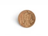 a close up of a coin on a white surface