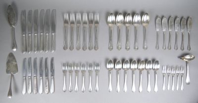 a lot of silver spoons and forks laid out on a table