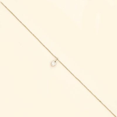 a close up of a gold chain with a small letter on it