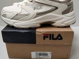 the fila sneakers are in a box on a table