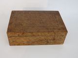 an old wooden box sitting on top of a white table