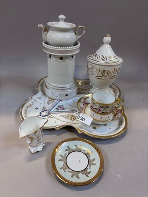 a white and gold tea set on a white table