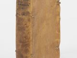 an old book sitting on top of a table next to a white background