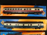 three toy trains sitting on top of each other on a table