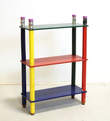 a multicolored shelf with two candles on it